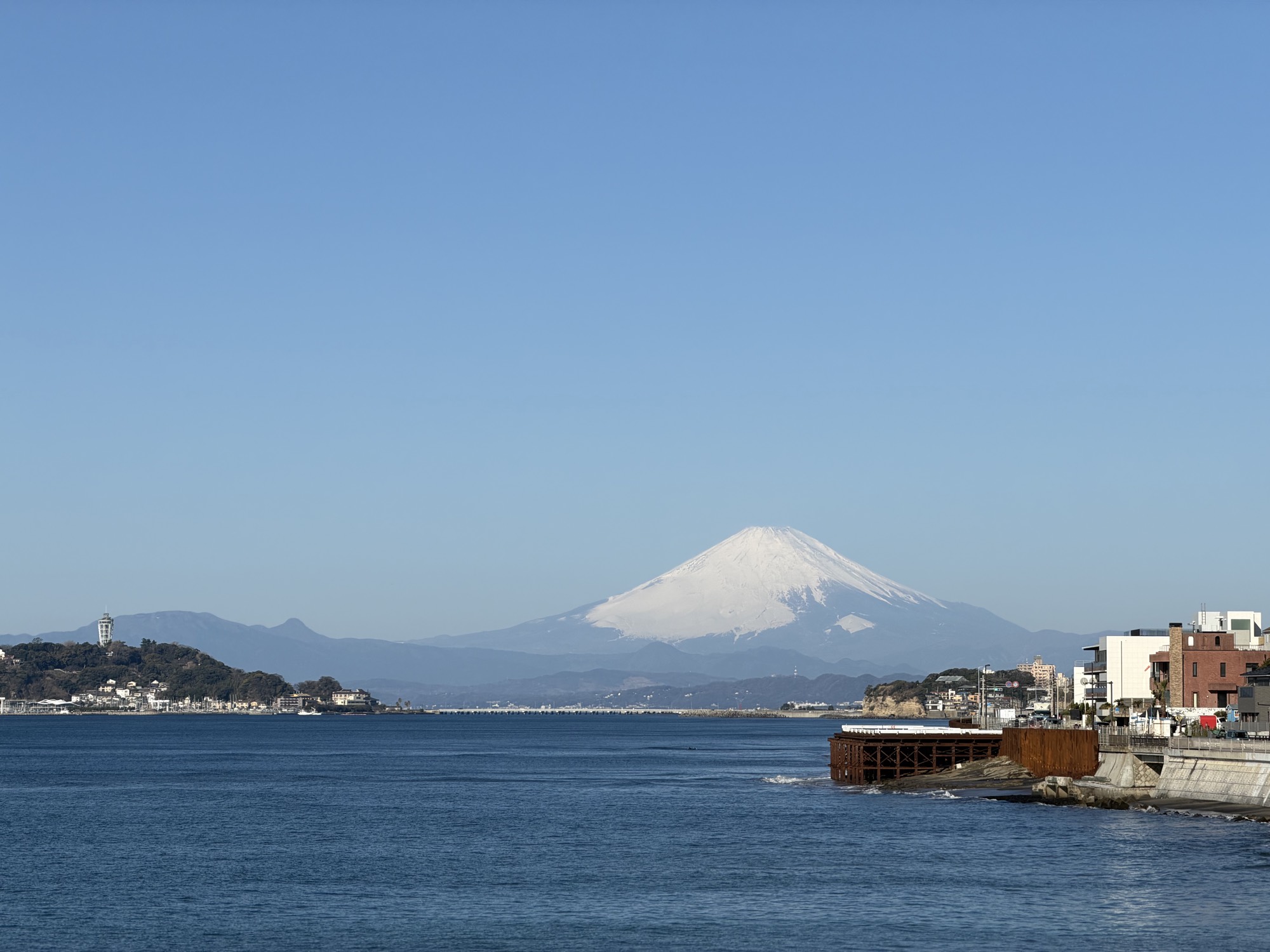 Mount Fuji rising over Sagami Bay, seen from the Kamakura coast on a clear morning